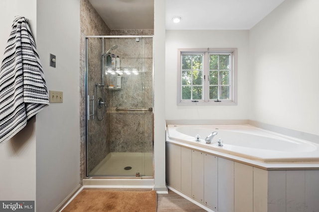 bathroom with shower with separate bathtub