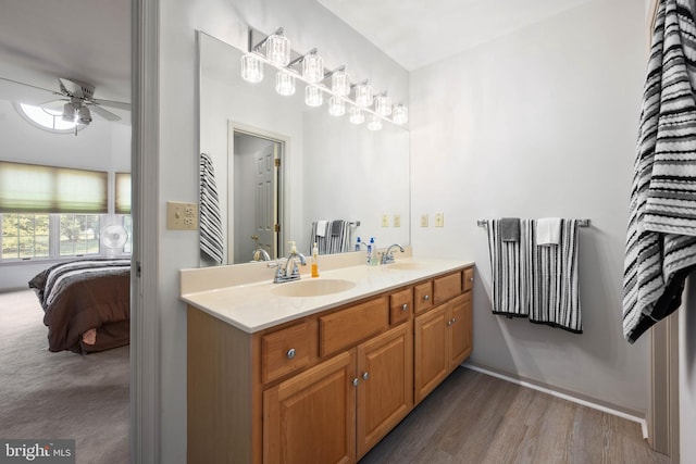 bathroom with ceiling fan, wood-type flooring, and double sink vanity