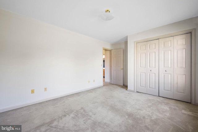 unfurnished bedroom with carpet and a closet