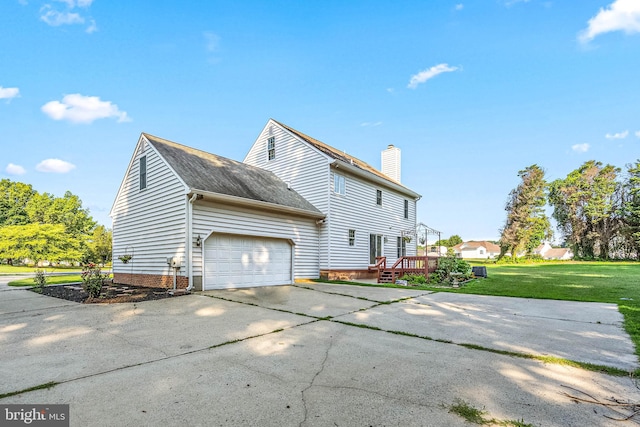 view of property exterior with a garage and a yard