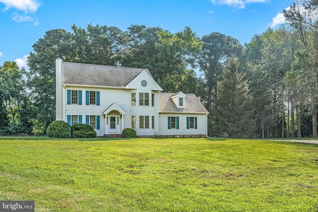 colonial-style house with a front lawn