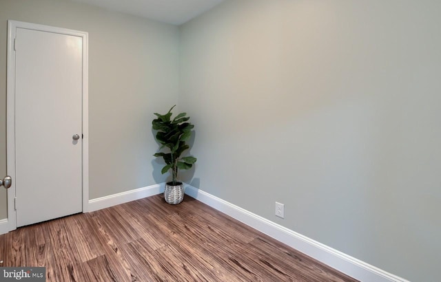 unfurnished room with wood-type flooring