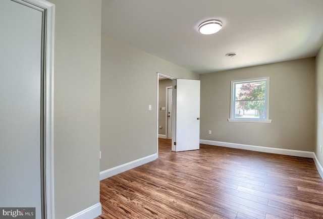 unfurnished room with hardwood / wood-style floors