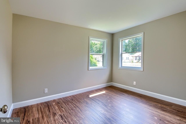 unfurnished room with hardwood / wood-style floors