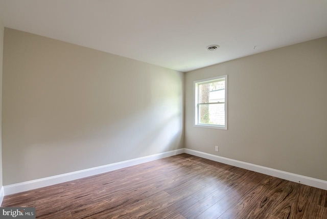 spare room featuring wood-type flooring