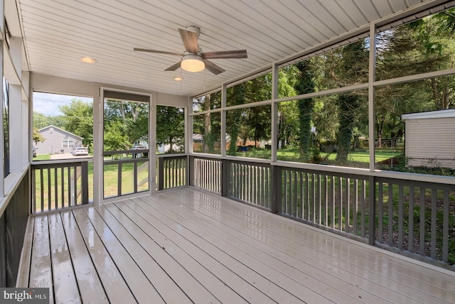 unfurnished sunroom featuring ceiling fan