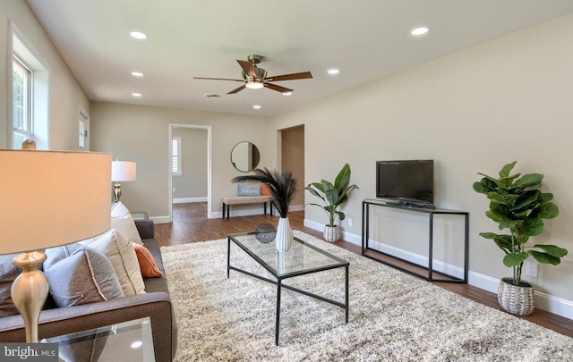 living room featuring dark hardwood / wood-style floors and ceiling fan