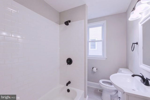 full bathroom with toilet, vanity, and tiled shower / bath