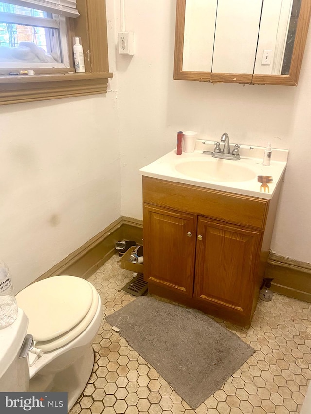 bathroom with vanity, toilet, and tile patterned flooring