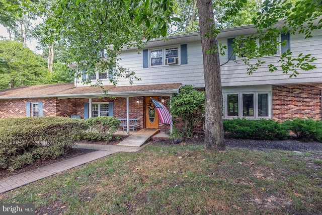 view of front of property featuring covered porch and cooling unit