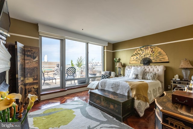 bedroom featuring access to exterior and parquet floors