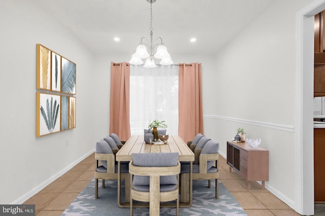 dining space featuring light tile patterned flooring and a notable chandelier