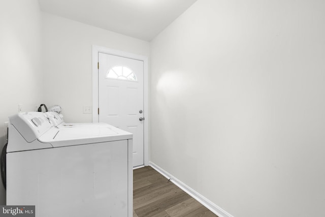 laundry area with dark wood-type flooring and washer and dryer