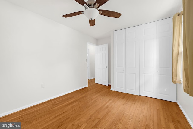 unfurnished bedroom with ceiling fan, a closet, and light wood-type flooring