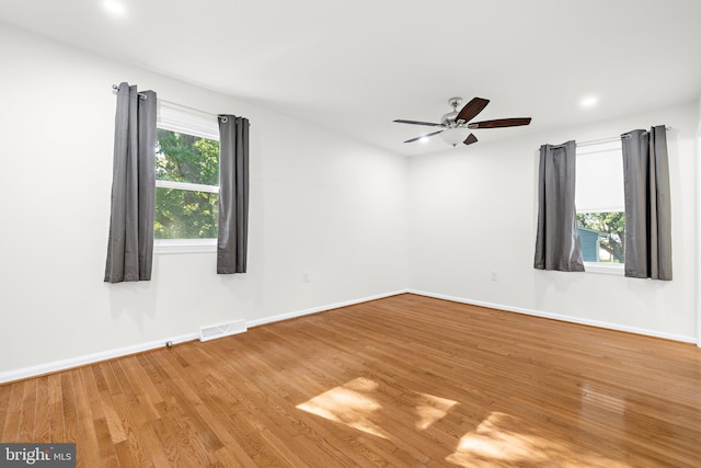 spare room featuring hardwood / wood-style flooring and ceiling fan