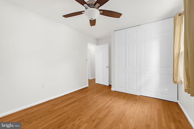 unfurnished bedroom with a closet, ceiling fan, and light wood-type flooring