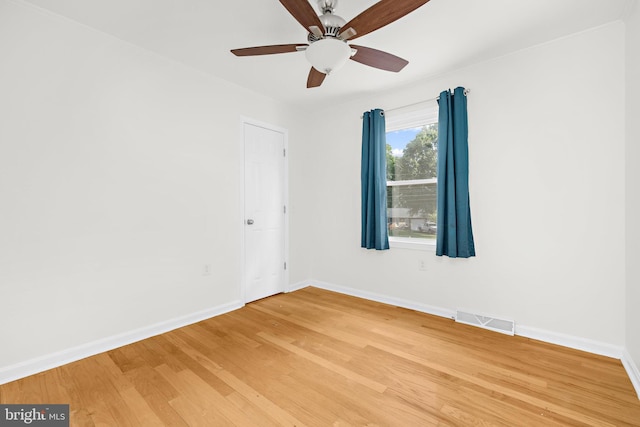 empty room with hardwood / wood-style flooring and ceiling fan