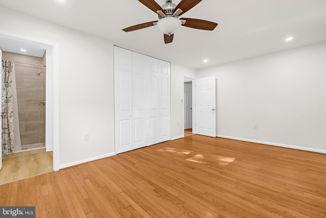 unfurnished bedroom featuring ceiling fan, connected bathroom, light hardwood / wood-style floors, and a closet