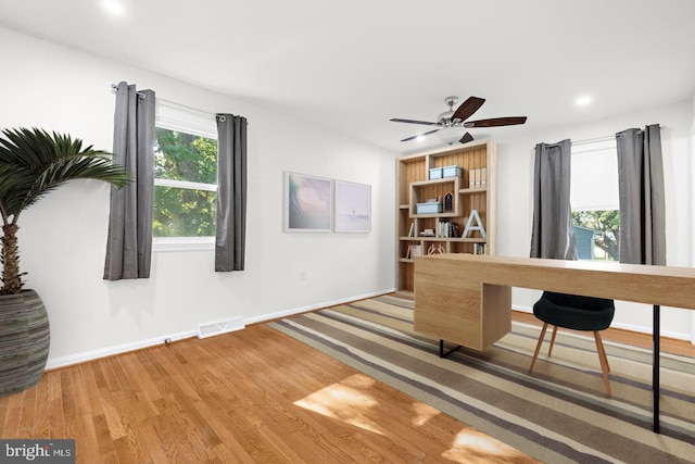 office area with hardwood / wood-style floors and ceiling fan