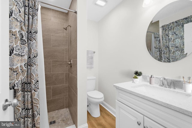 bathroom featuring hardwood / wood-style flooring, vanity, a shower with shower curtain, and toilet