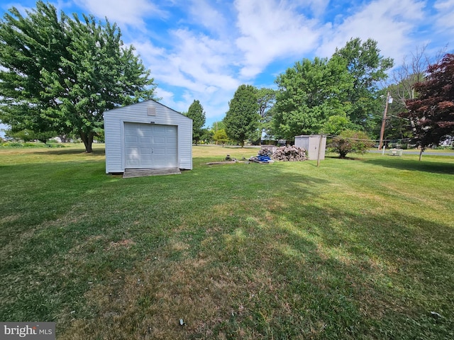 view of yard featuring an outbuilding and a garage