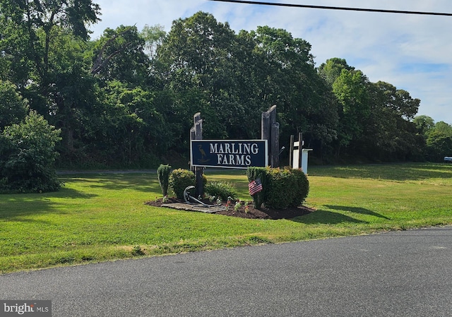 community / neighborhood sign with a yard