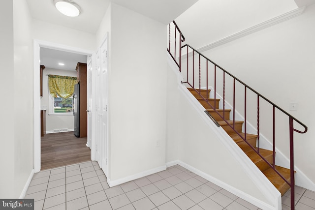 stairs featuring tile patterned floors