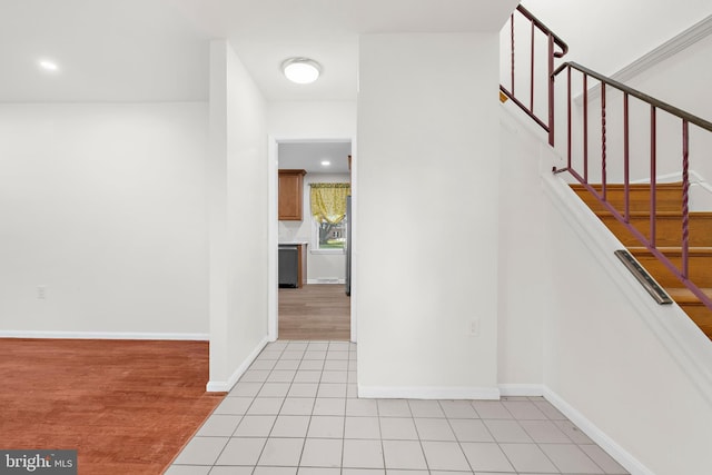 staircase featuring tile patterned floors