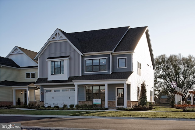 view of front of home with a front yard and a garage