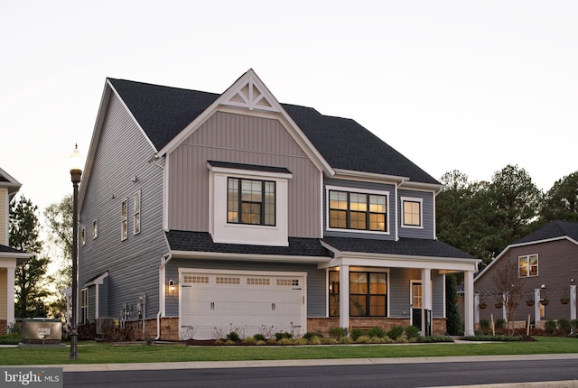 view of front of home with a front yard and a garage