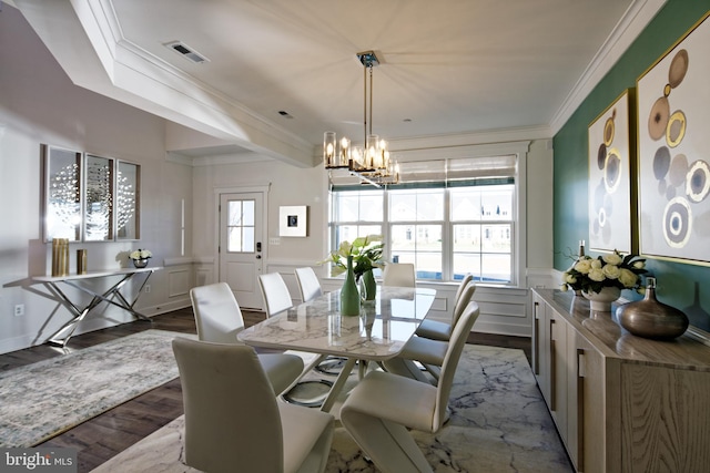 dining space with a chandelier, light wood-type flooring, and crown molding