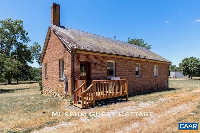 rear view of house featuring a wooden deck