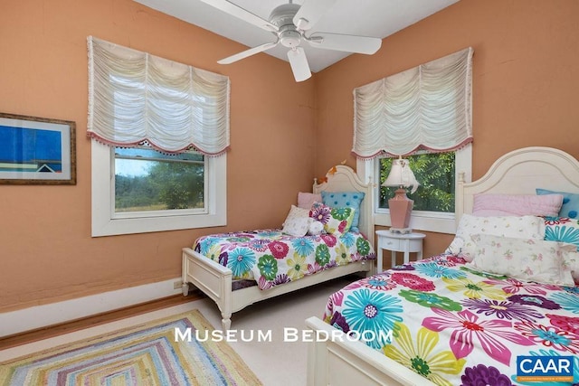 bedroom featuring multiple windows and ceiling fan