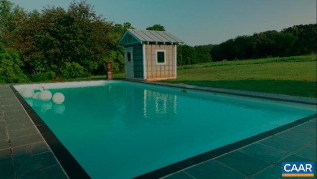 view of pool with a lawn