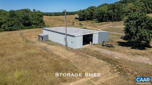 view of outdoor structure with a rural view