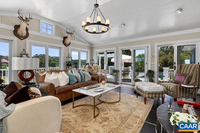 sunroom / solarium with french doors, a healthy amount of sunlight, lofted ceiling, and a notable chandelier