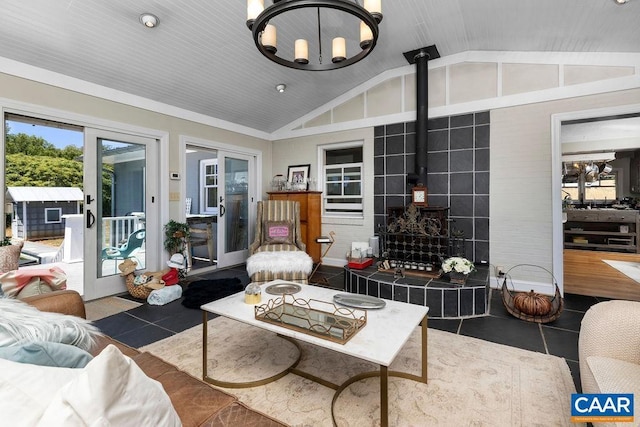 living room featuring dark tile patterned floors, french doors, and vaulted ceiling