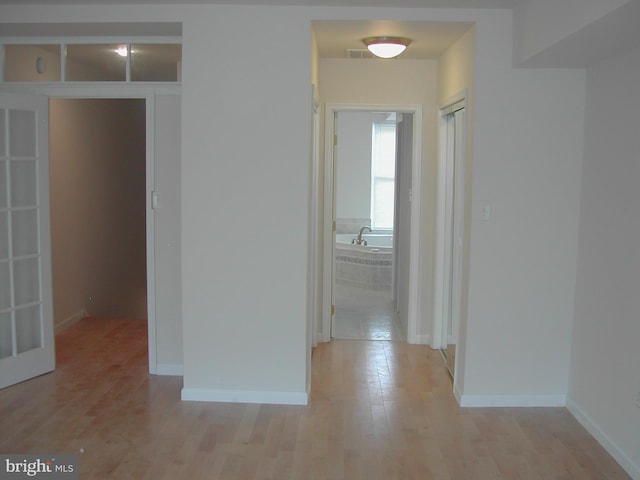 corridor with light wood-type flooring