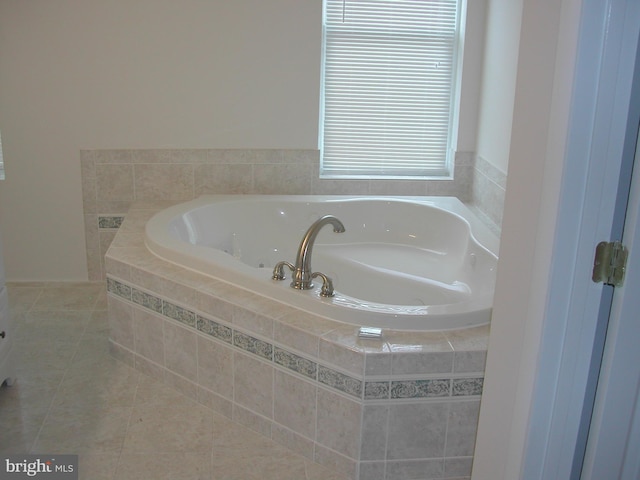 bathroom featuring tile patterned flooring and tiled bath