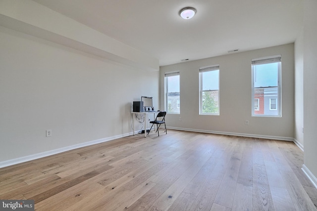 unfurnished office with light hardwood / wood-style floors