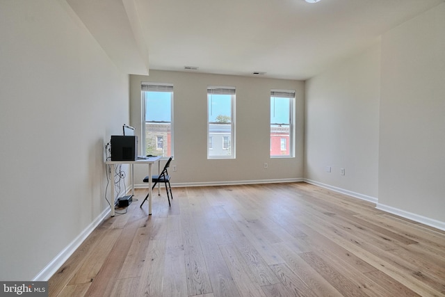 unfurnished office with light hardwood / wood-style flooring