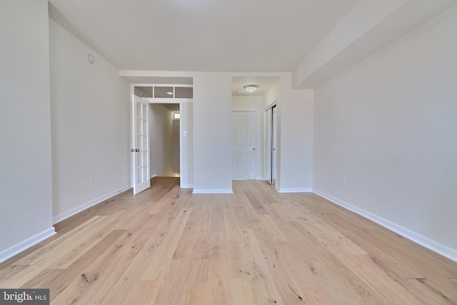 unfurnished bedroom with a closet and light wood-type flooring