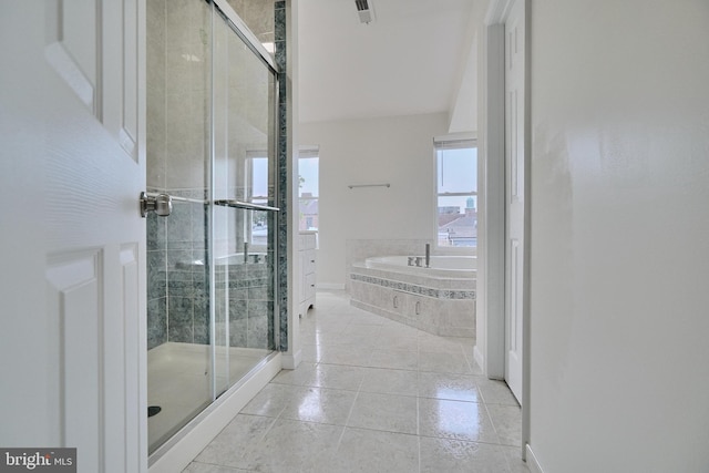 bathroom with independent shower and bath and tile patterned floors