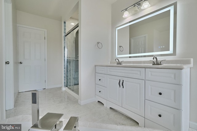 bathroom featuring a shower with door, tile patterned floors, and double sink vanity