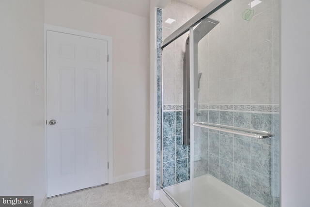 bathroom with tile patterned flooring and walk in shower