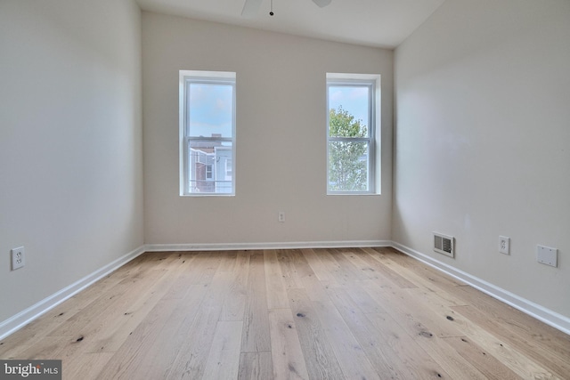 spare room with light hardwood / wood-style flooring, ceiling fan, and vaulted ceiling