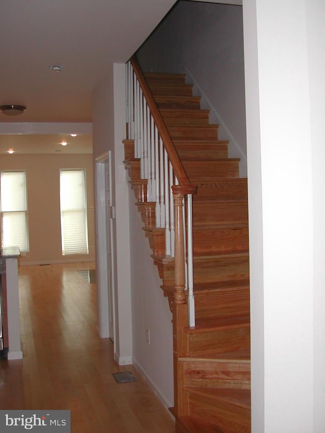 stairs featuring hardwood / wood-style flooring