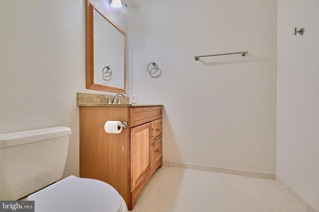 bathroom featuring tile patterned floors, toilet, and vanity