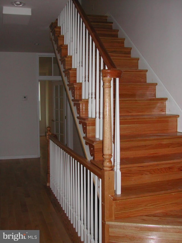 stairs featuring hardwood / wood-style flooring