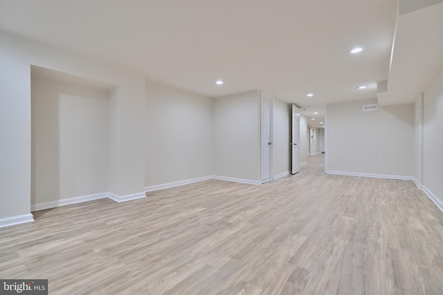 basement with light hardwood / wood-style flooring